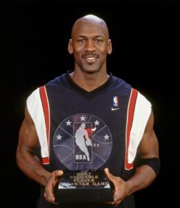 Michael Jordan with the 1998 NBA All Star MVP trophy