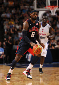 Pops wearing a similar jersey behind Lebron James